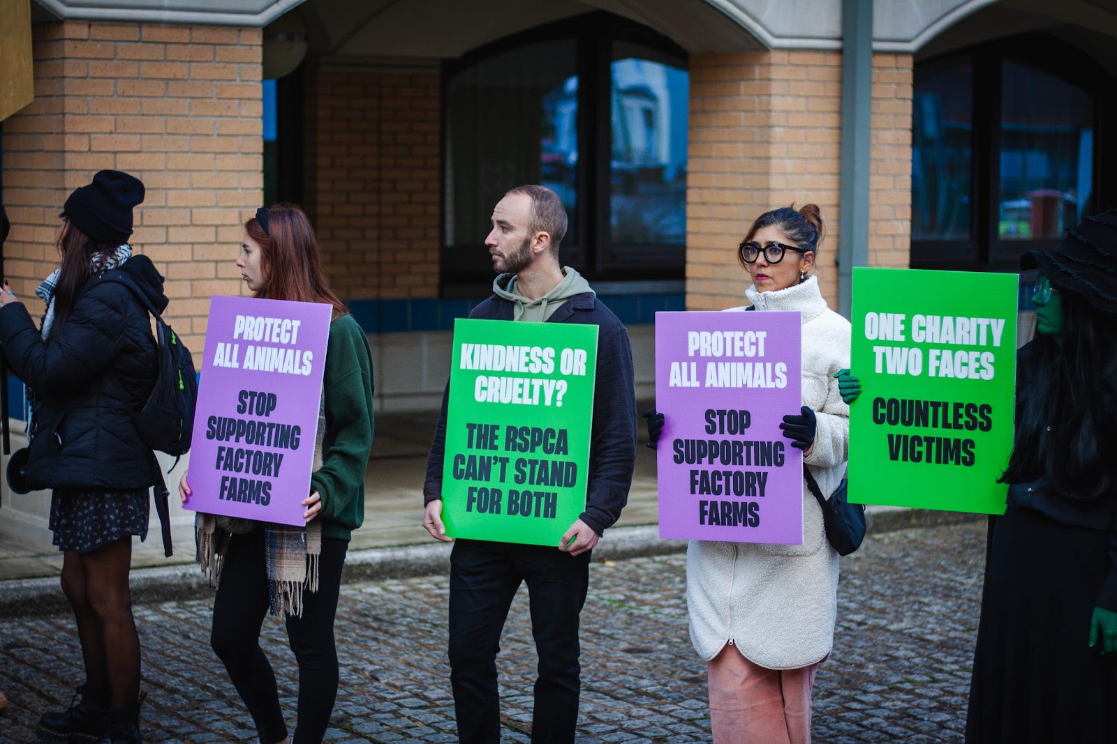 Protestors holding placards: 'Stop supporting factory farms'