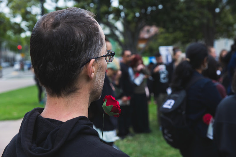 Activist holding a rose - Funeral for farm animals at the Animal Liberation Conference 2018